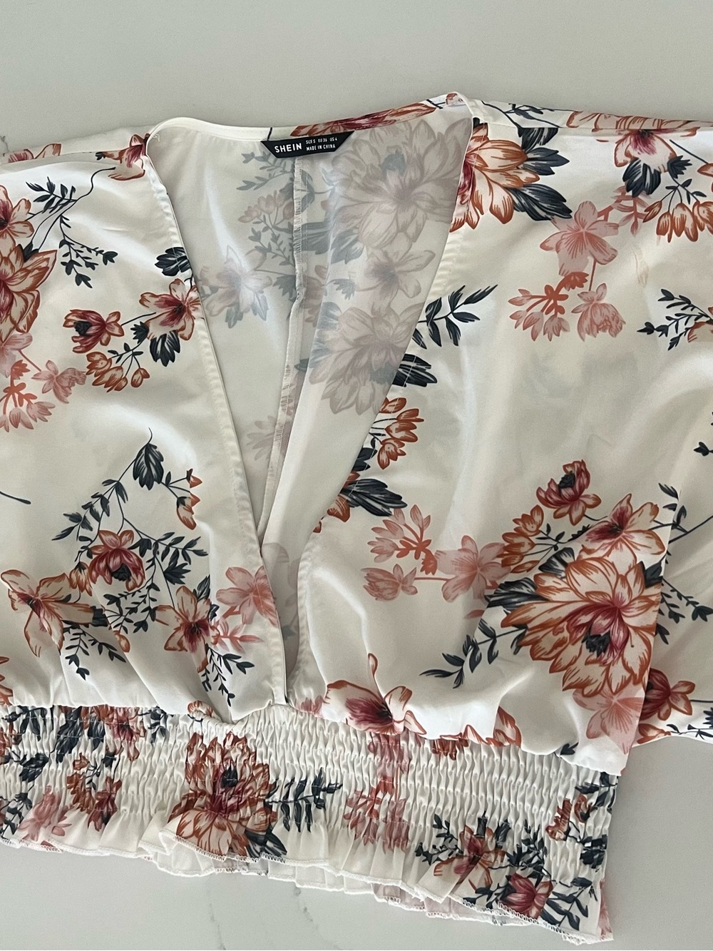 SHEIN White Floral V-Neck Smocked Hem Blouse
